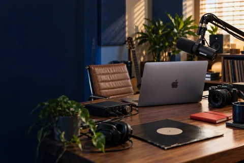 Creator workspace with a MacBook, camera and microphone
